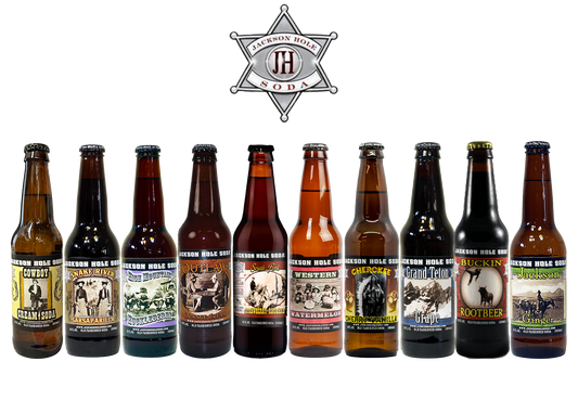 Assorted bottles of Jackson Hole Drinks, featuring bold, smooth craft soda flavors with lively fizz and refreshing taste.