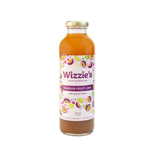Glass bottle of Wizzie's Passion Fruit Lime tea with limes and passionfruits on a white label.