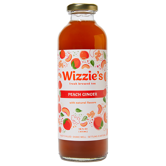 Glass Wizzie's Peach Ginger bottle with peaches and ginger clusters on a white label.